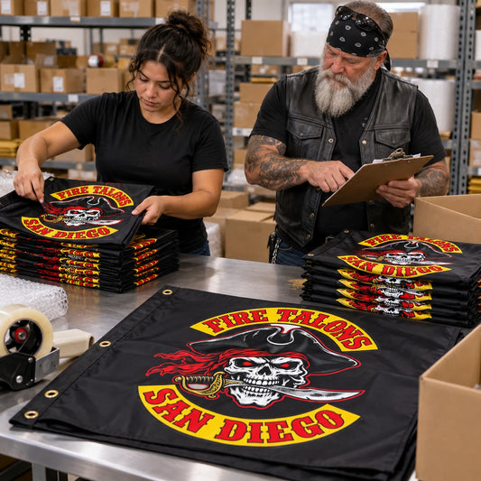 A coordinated bulk order of custom motorcycle club flags is counted and packed for chapter delivery.