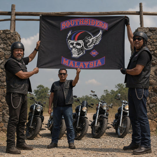 A road captain raises a classic rectangular custom club flag at a gravel motorcycle rally entrance.