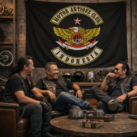 Three motorcycle club members relax beneath a custom chapter flag in an industrial clubhouse lounge.