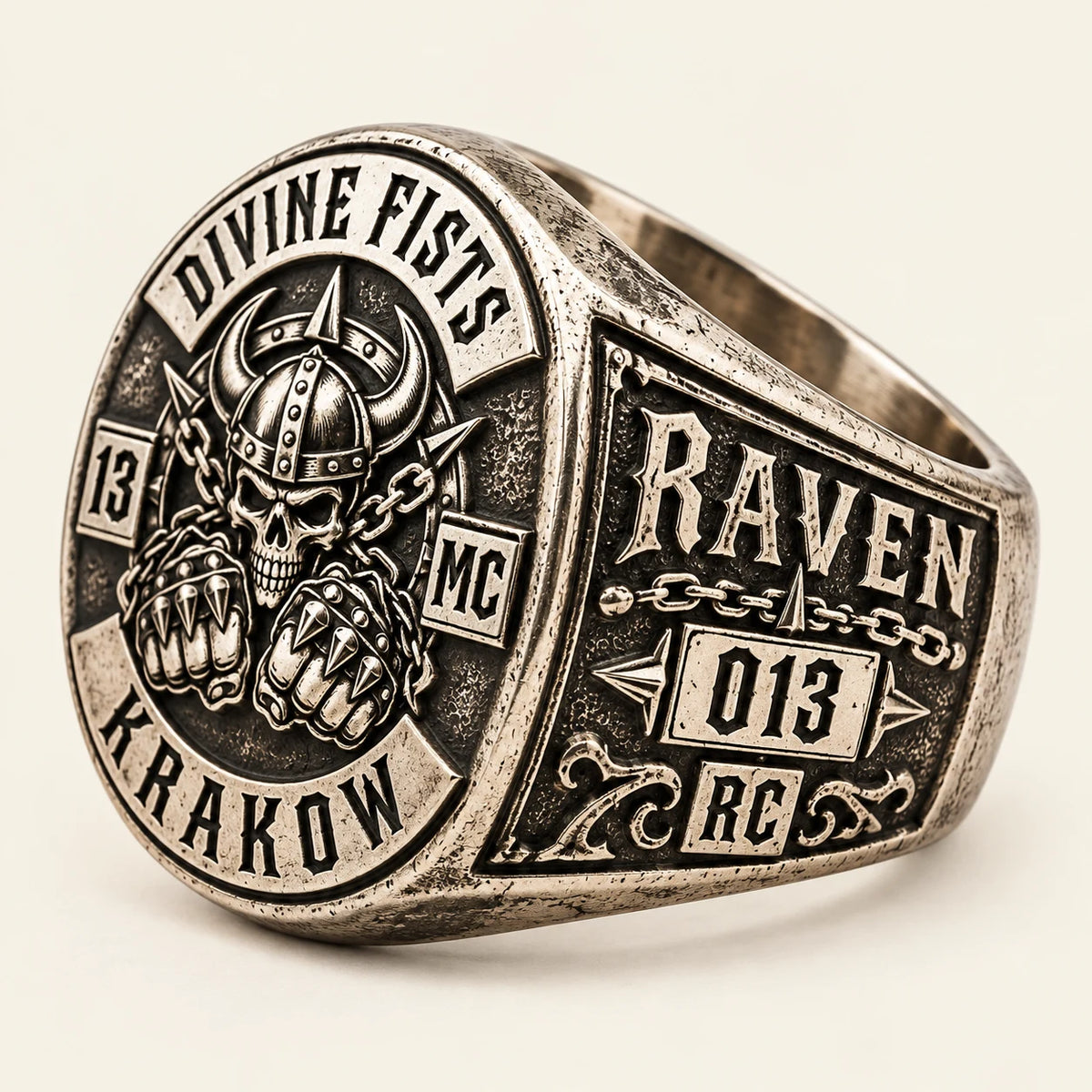 Right-side view of a white copper Divine Fists motorcycle club ring showing a road name and member number on the shoulder.