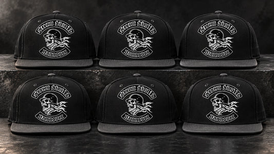 Matching motorcycle club snapback hats prepared for coordinated chapter orders.