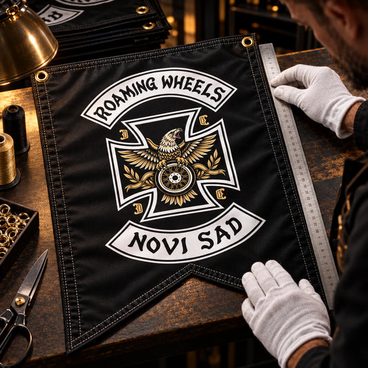 Quality inspector checking print, stitching and finishing on a premium flag for a motorcycle club.