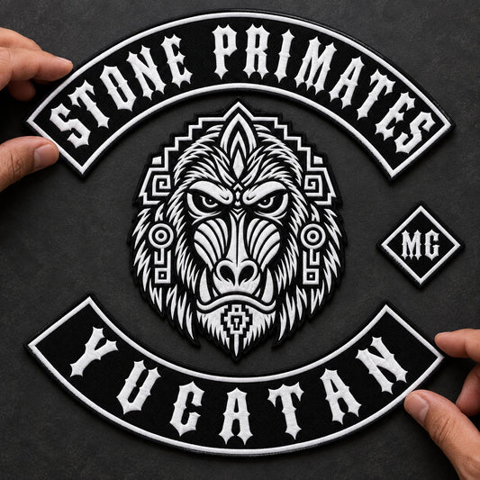 Separate custom motorcycle club top and bottom rocker patches aligned around a center emblem on a layout table.