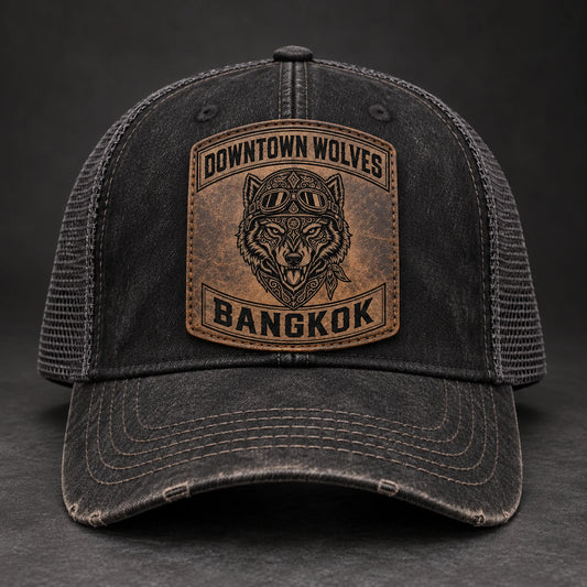 Vintage-washed black motorcycle club trucker hat with leather patch and mesh back.