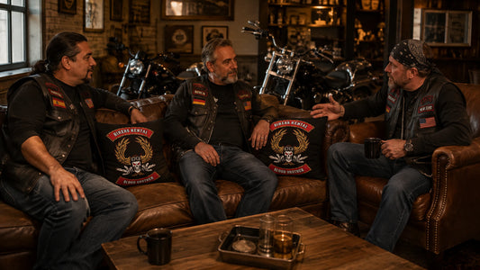 Motorcycle club members gather around custom logo pillows in a clubhouse lounge.