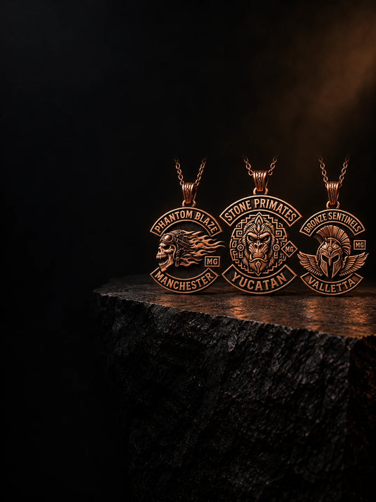 Three complete custom pure copper motorcycle club pendants with short chain details in a premium jewelry studio.