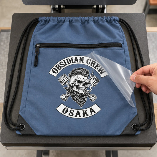 Detailed multi-color motorcycle club artwork is applied to a drawstring bag by heat transfer.