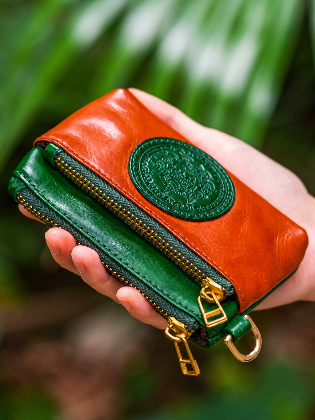 compact orange and green leather biker wallet held in hand