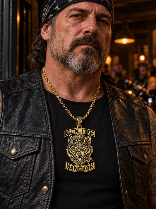 Downtown Wolves gold-plated club pendant concept worn at a realistic scale over a black leather vest.