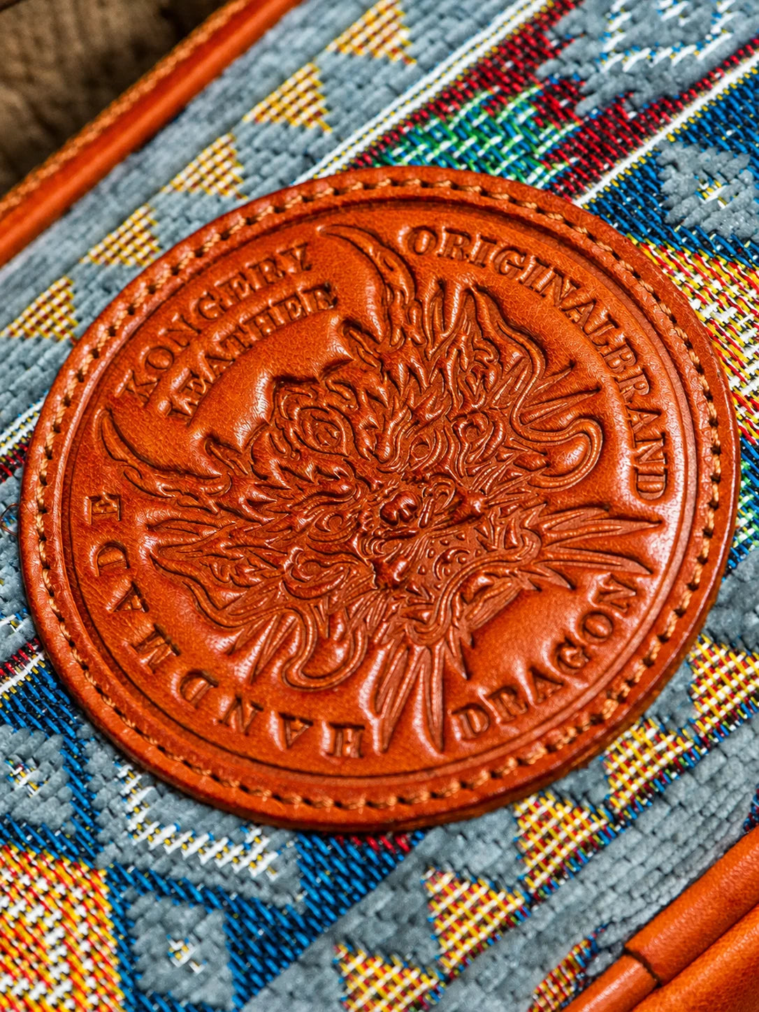 close-up of embossed dragon medallion and woven textile panel