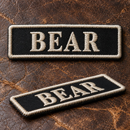 Macro product photograph of classic raised embroidery on durable twill motorcycle club name bars, showing custom motorcycle club name bar patch options.