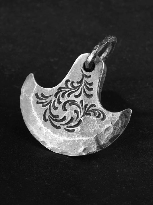 Detail view of engraved axe sterling silver biker pendant