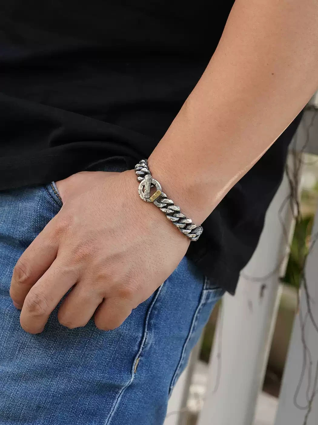 antique finish Cuban link bracelet on a man's wrist