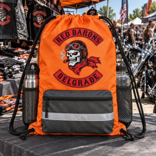 A custom motorcycle club drawstring bag is displayed at a busy bike-week merchandise booth.