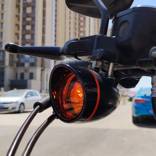 Black Fangster turn signal housing with amber lens installed on a Harley-Davidson motorcycle