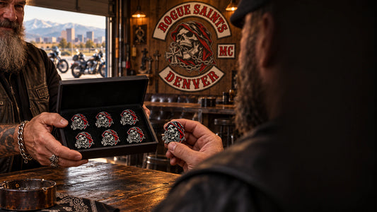 Motorcycle club members exchanging a presentation box of custom ROGUE SAINTS 3D pins in a clubhouse.