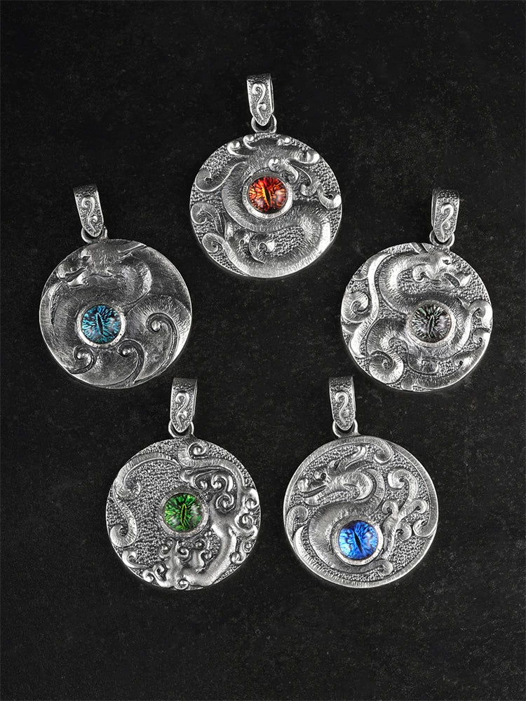 Five Chinese dragon medallion pendant designs arranged on black