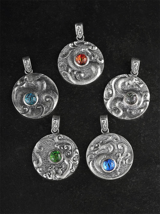 Five Chinese dragon medallion pendant designs arranged on black