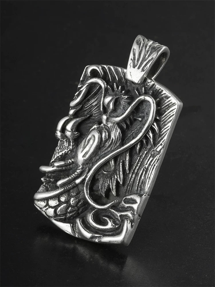 Flying dragon relief sterling silver biker pendant angled view