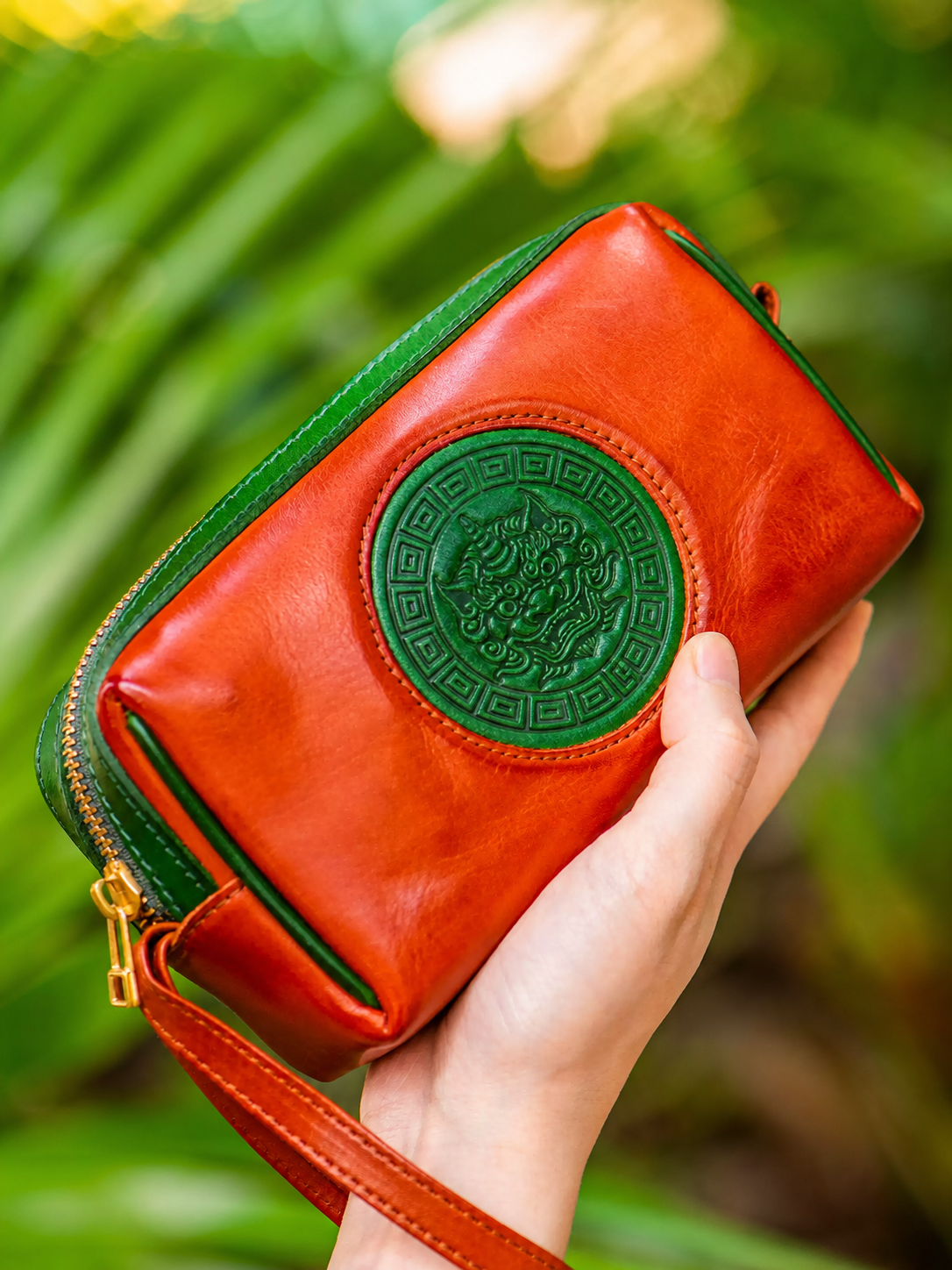 reddish brown fortune guardian leather biker clutch wallet held in hand