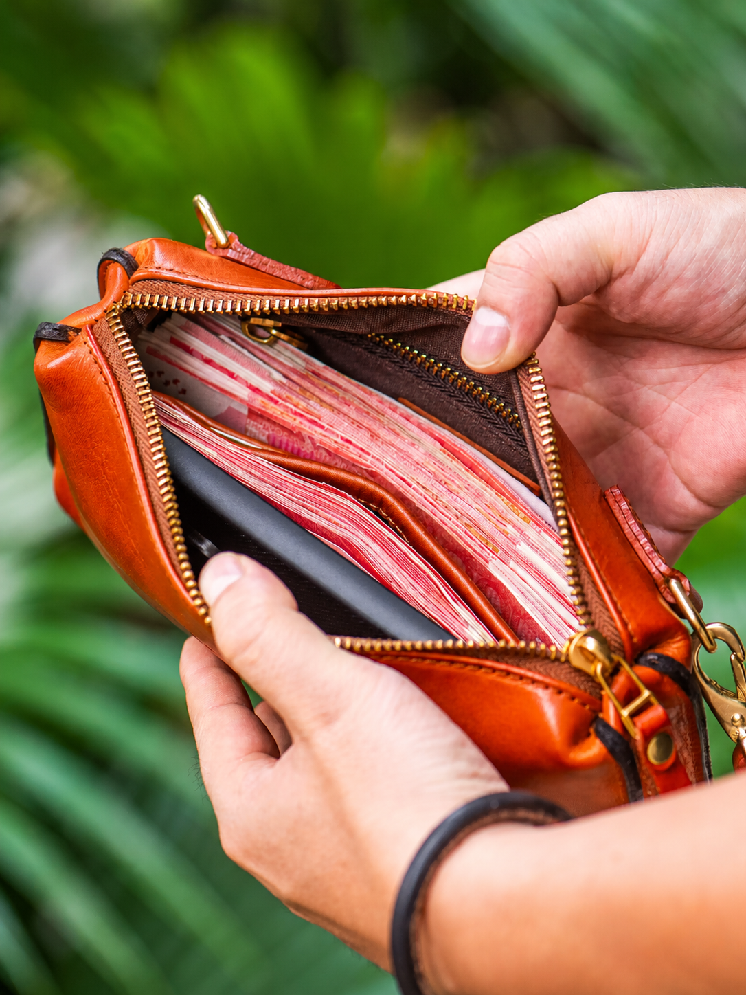 open leather biker wallet showing organized cash and phone storage
