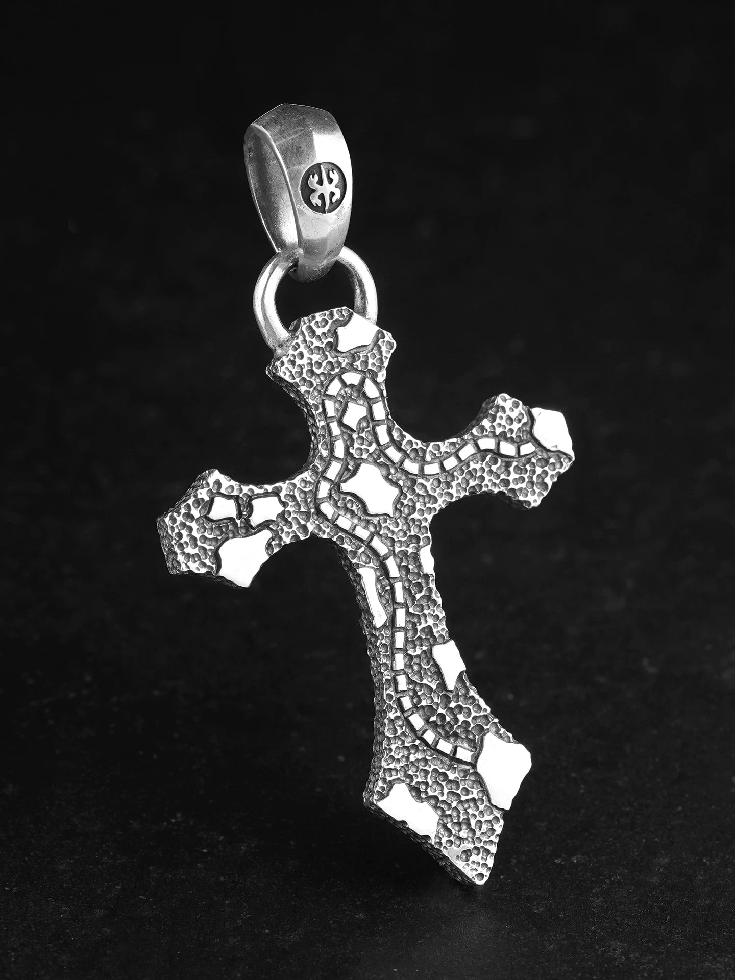 Back view of hand-carved four-point star cross silver pendant