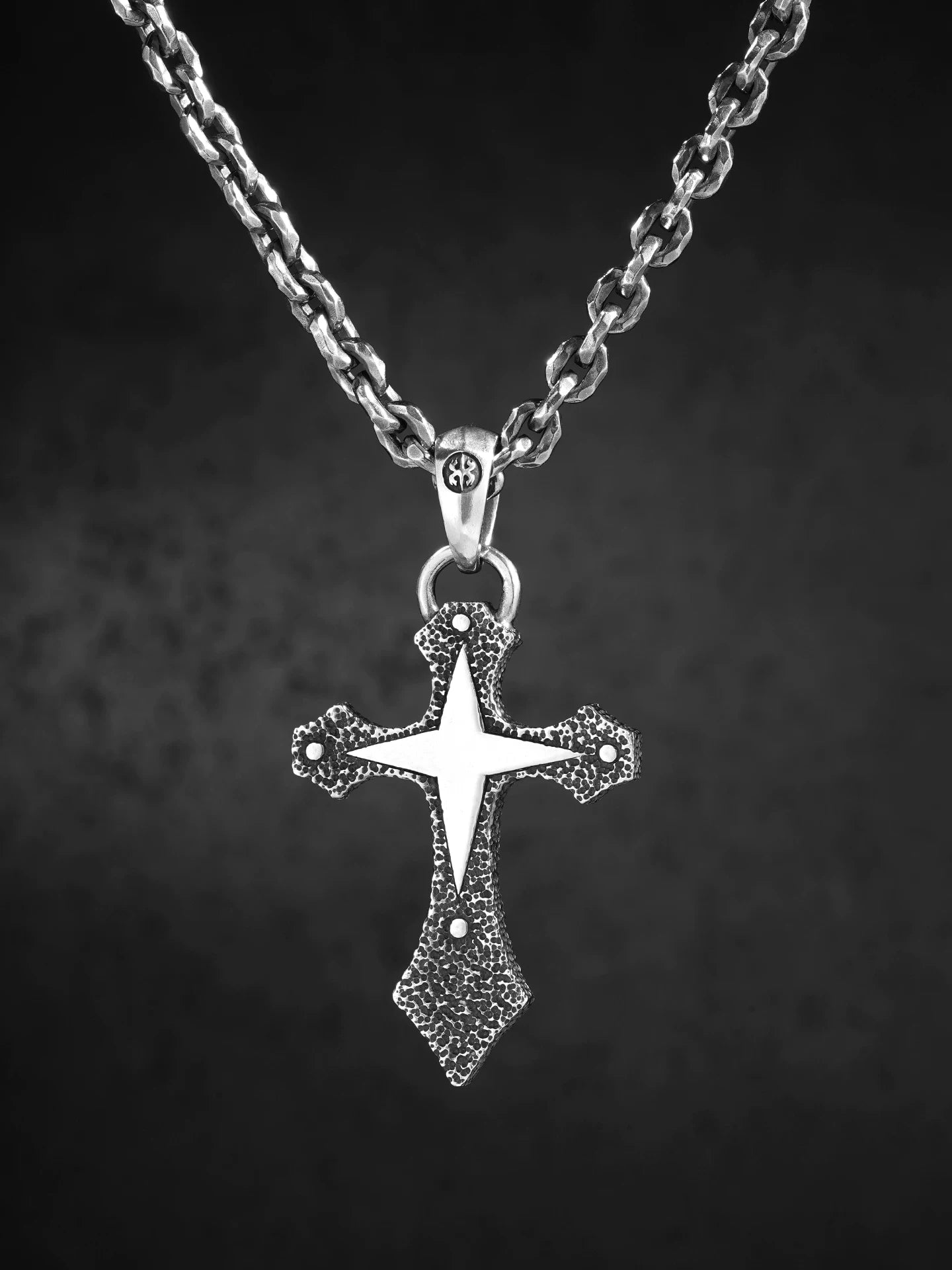 Four-point star cross sterling silver biker pendant shown on chain