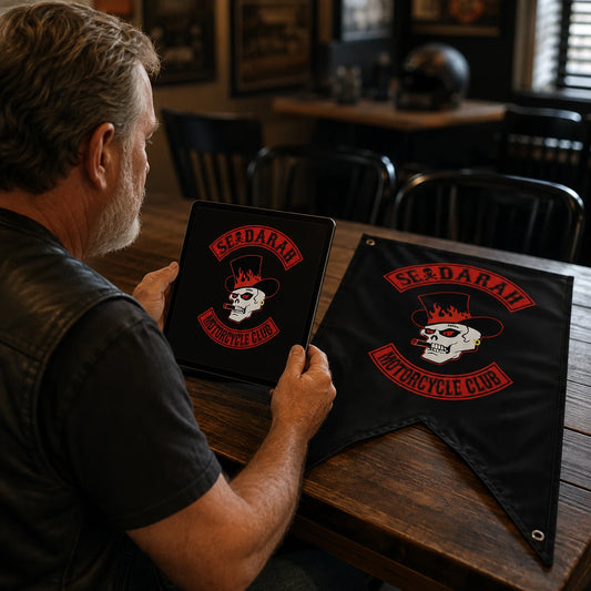 A production designer refines approved motorcycle club artwork into a manufacturing-ready triangle flag layout.