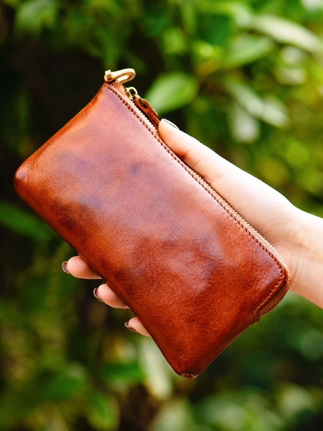 Mocha Brown leather biker phone wallet shown in hand