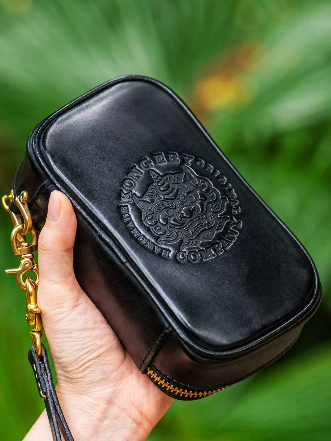 back view of black leather biker organizer with embossed guardian motif