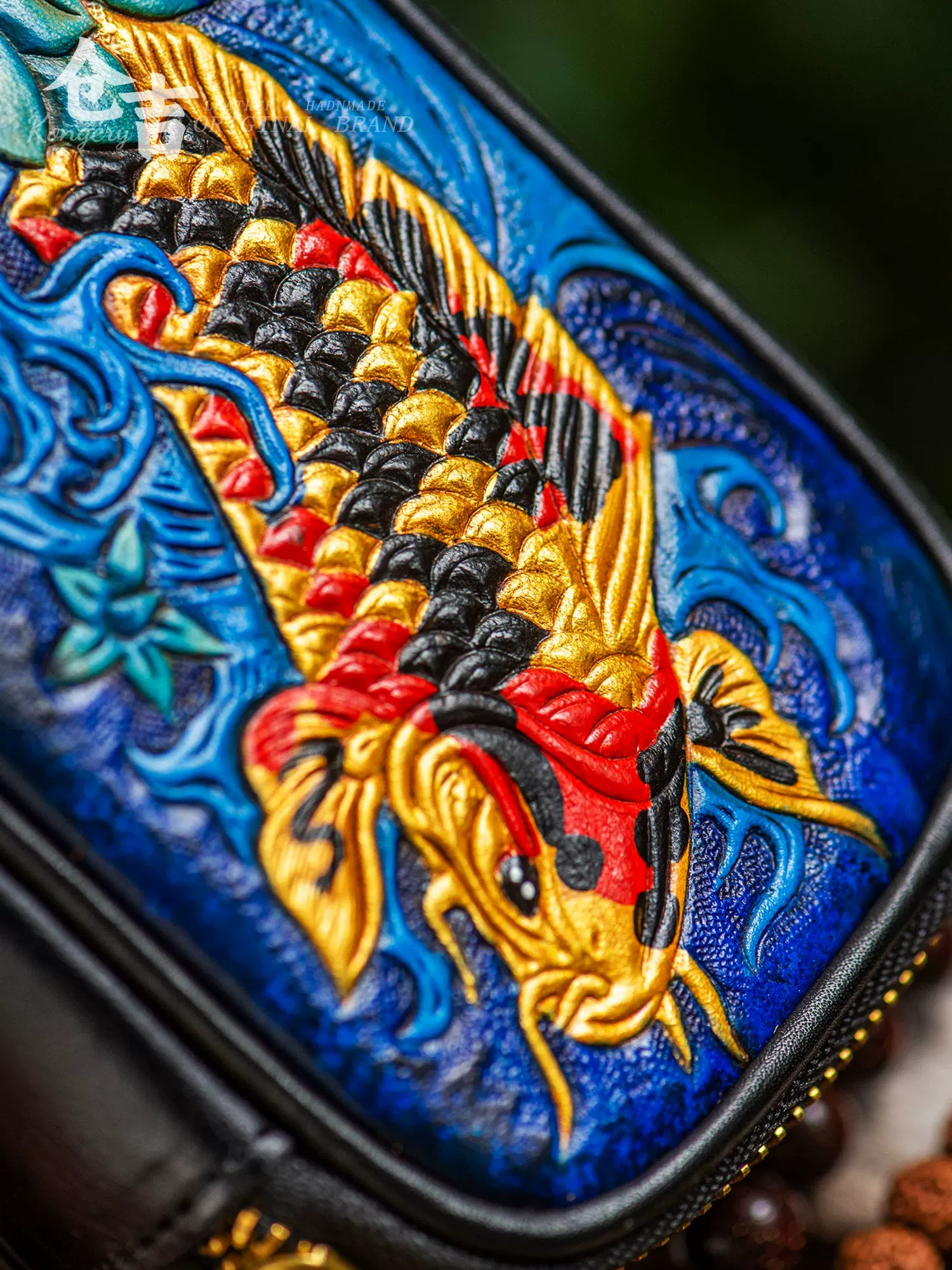 close-up of hand-carved golden koi leather artwork