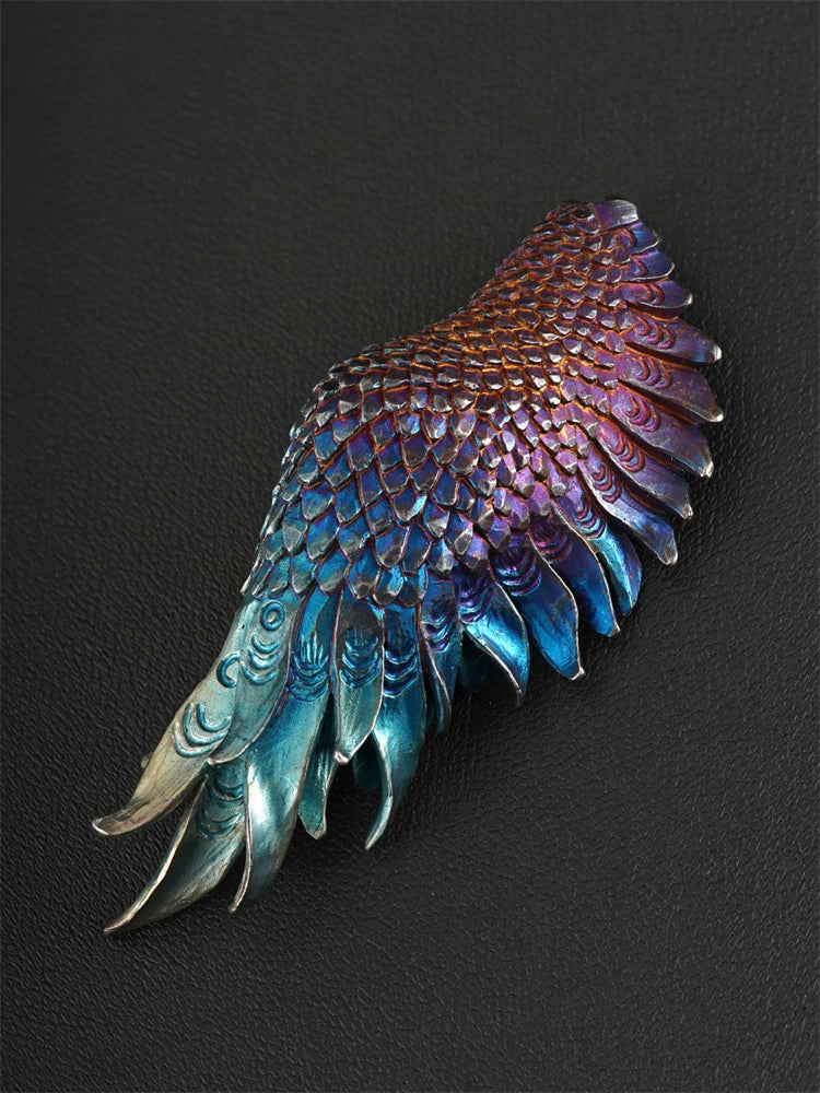 Close view of heat-colored guardian wing sterling silver pendant