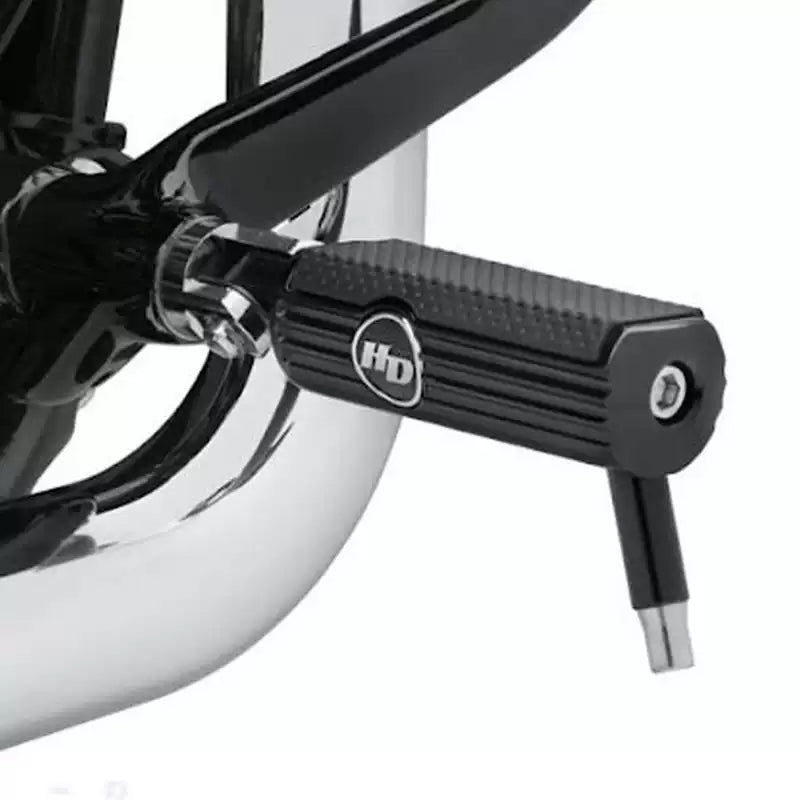 Black Harley front foot peg installed on a motorcycle