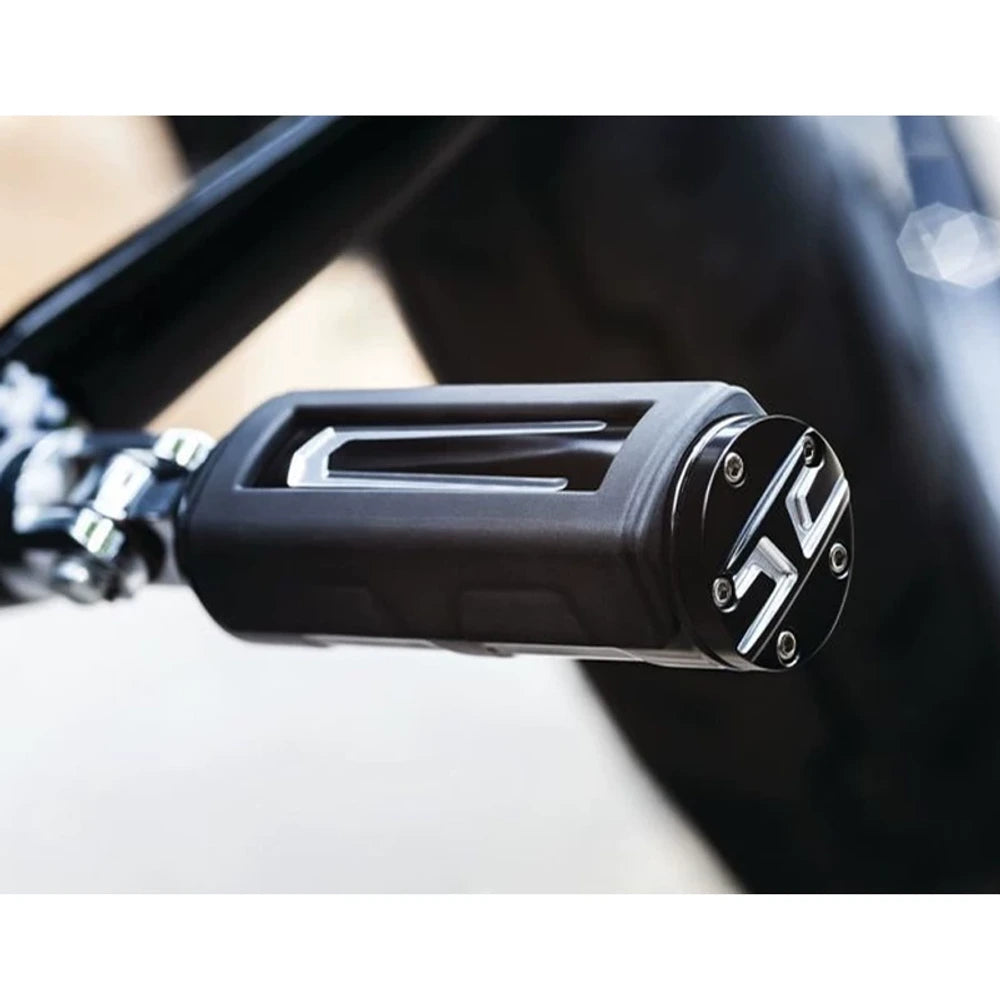 Close-up of a chrome and black mini Harley foot peg installed