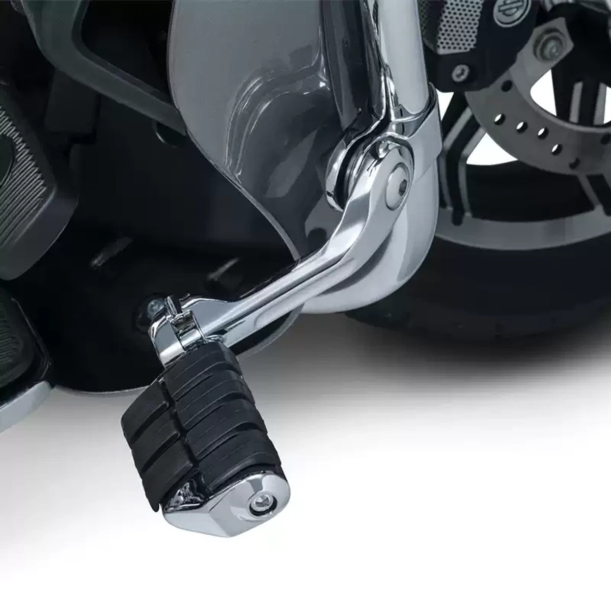 Chrome rectangular highway cruise foot peg installed on a compatible Harley motorcycle