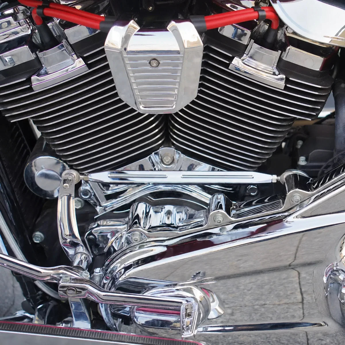 Chrome 34850-09 shift linkage rod installed across a motorcycle V-twin engine