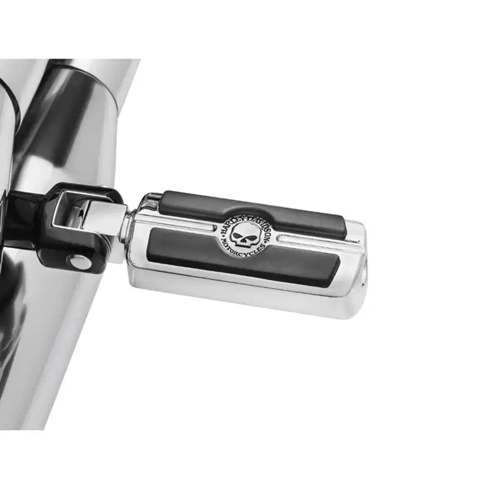 Chrome skull foot peg close-up installed on a Harley motorcycle