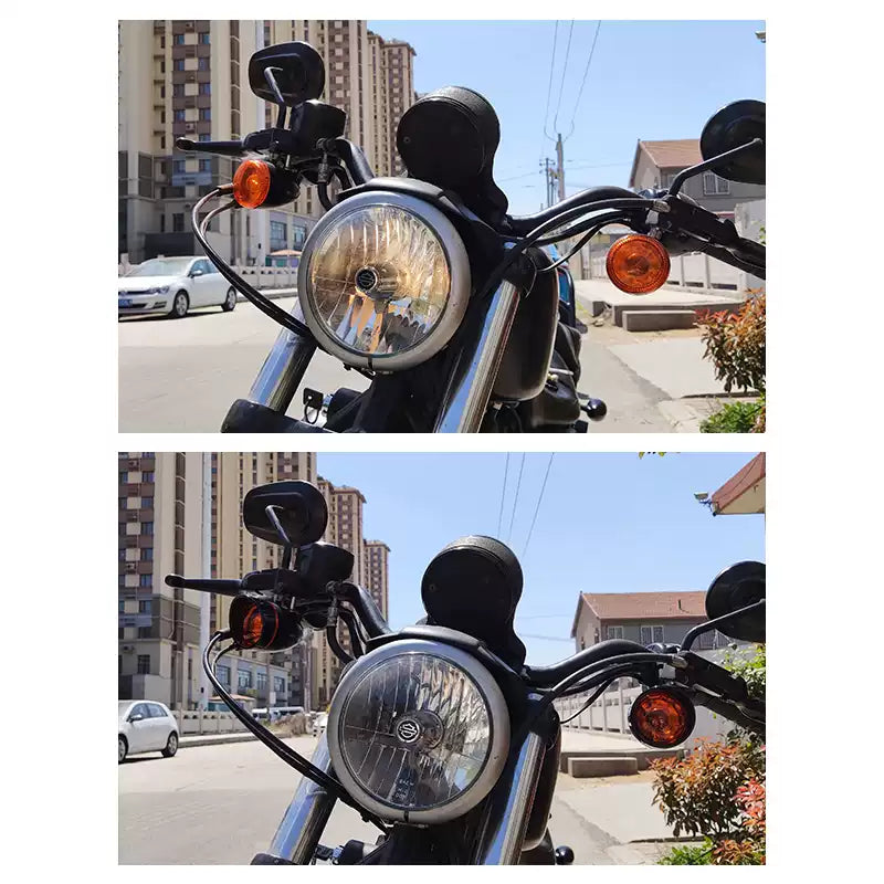 Chrome and amber front turn signal housings installed on a Harley-Davidson motorcycle