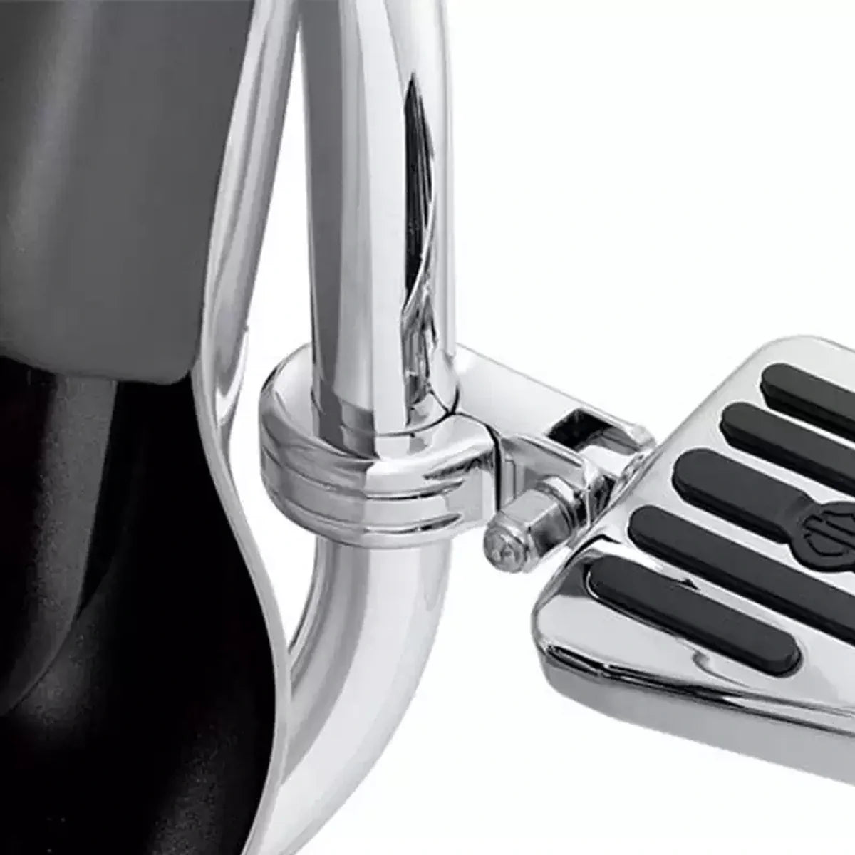 Chrome highway cruise foot peg installed on a motorcycle engine guard