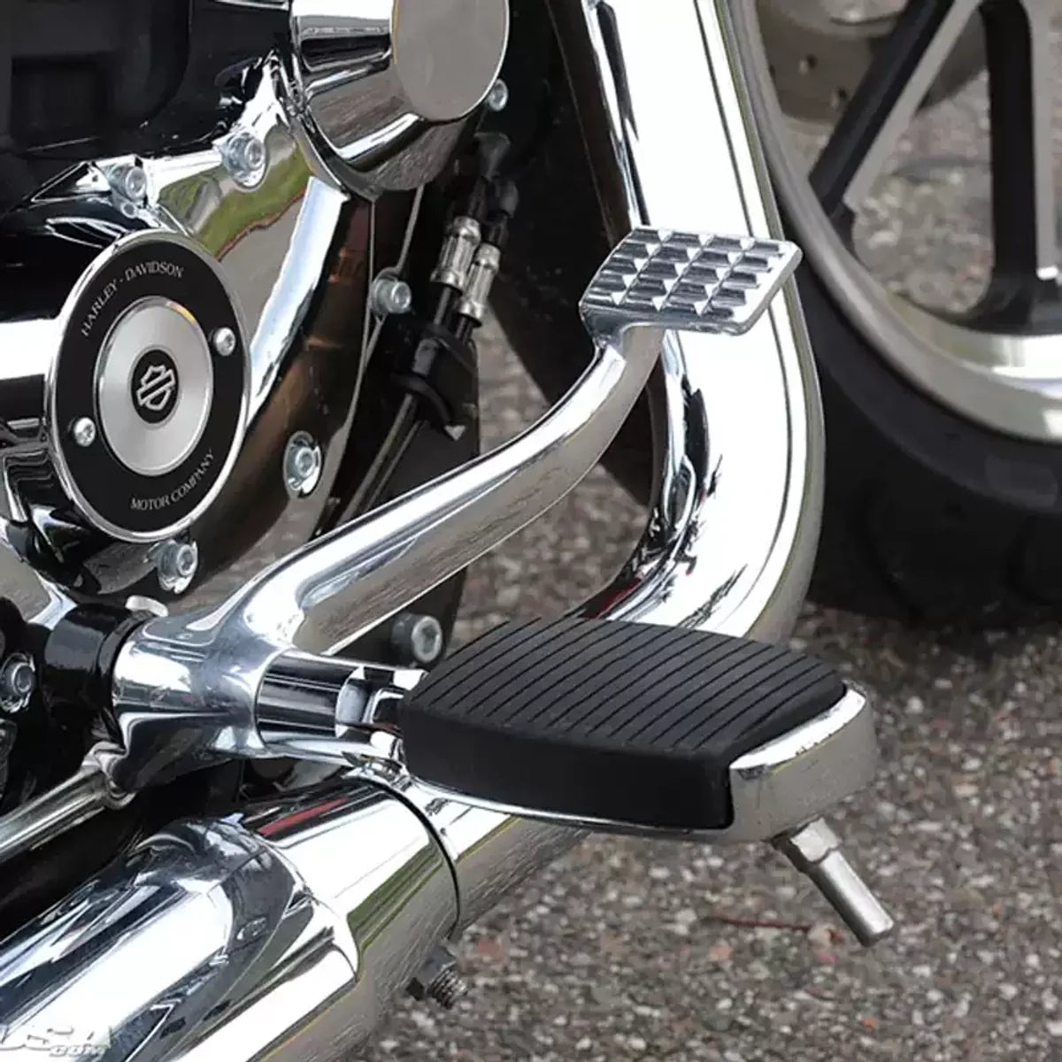 Highway cruise foot peg shown in rider foot-support position on a Harley motorcycle