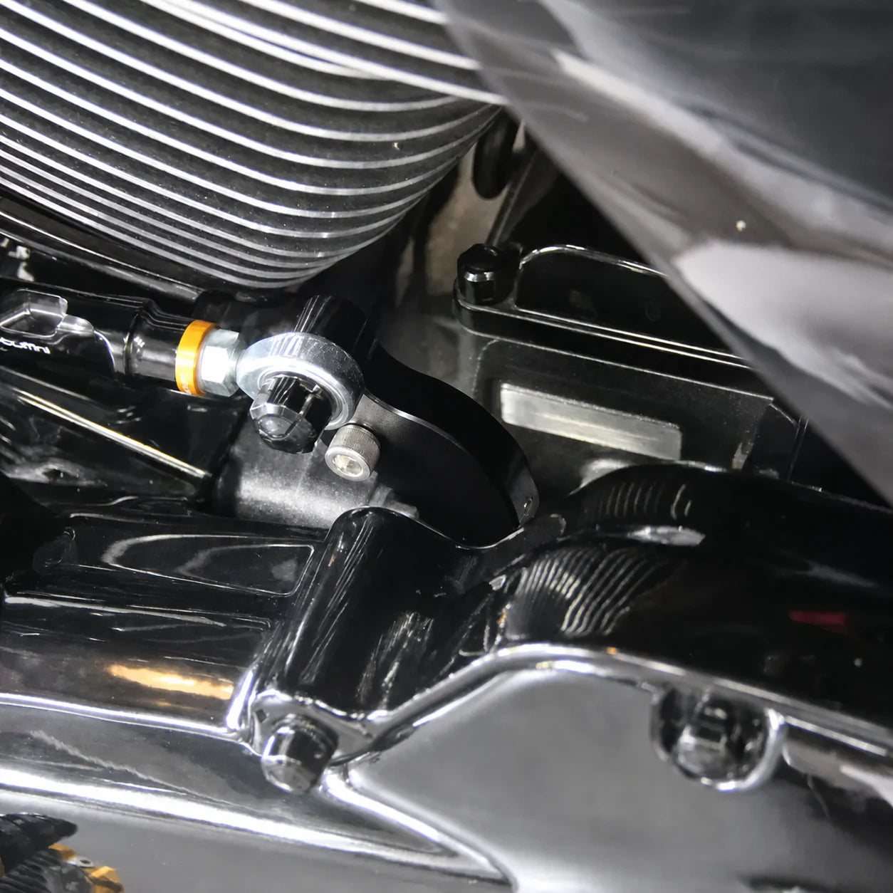 Close-up of Harley neutral finder bracket mounted beside the shift linkage
