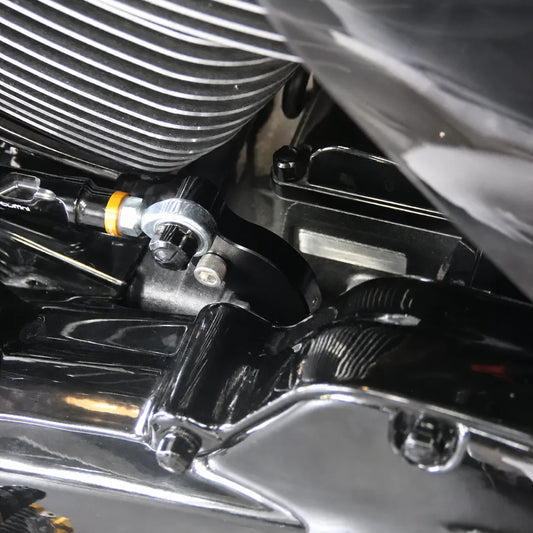 Close-up of Harley neutral finder bracket mounted beside the shift linkage