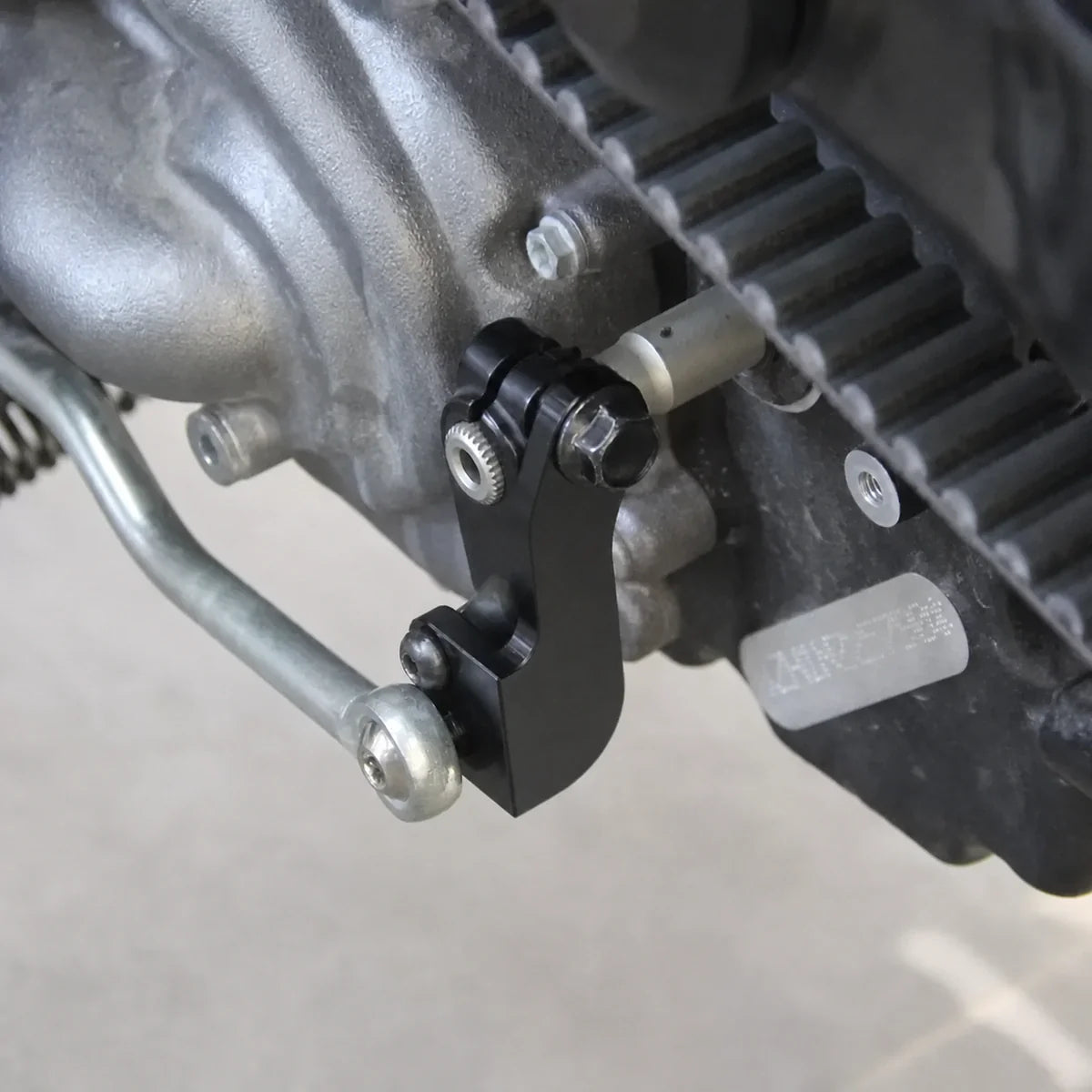 Black shift assist bracket installed close-up on a Harley Nightster RH975