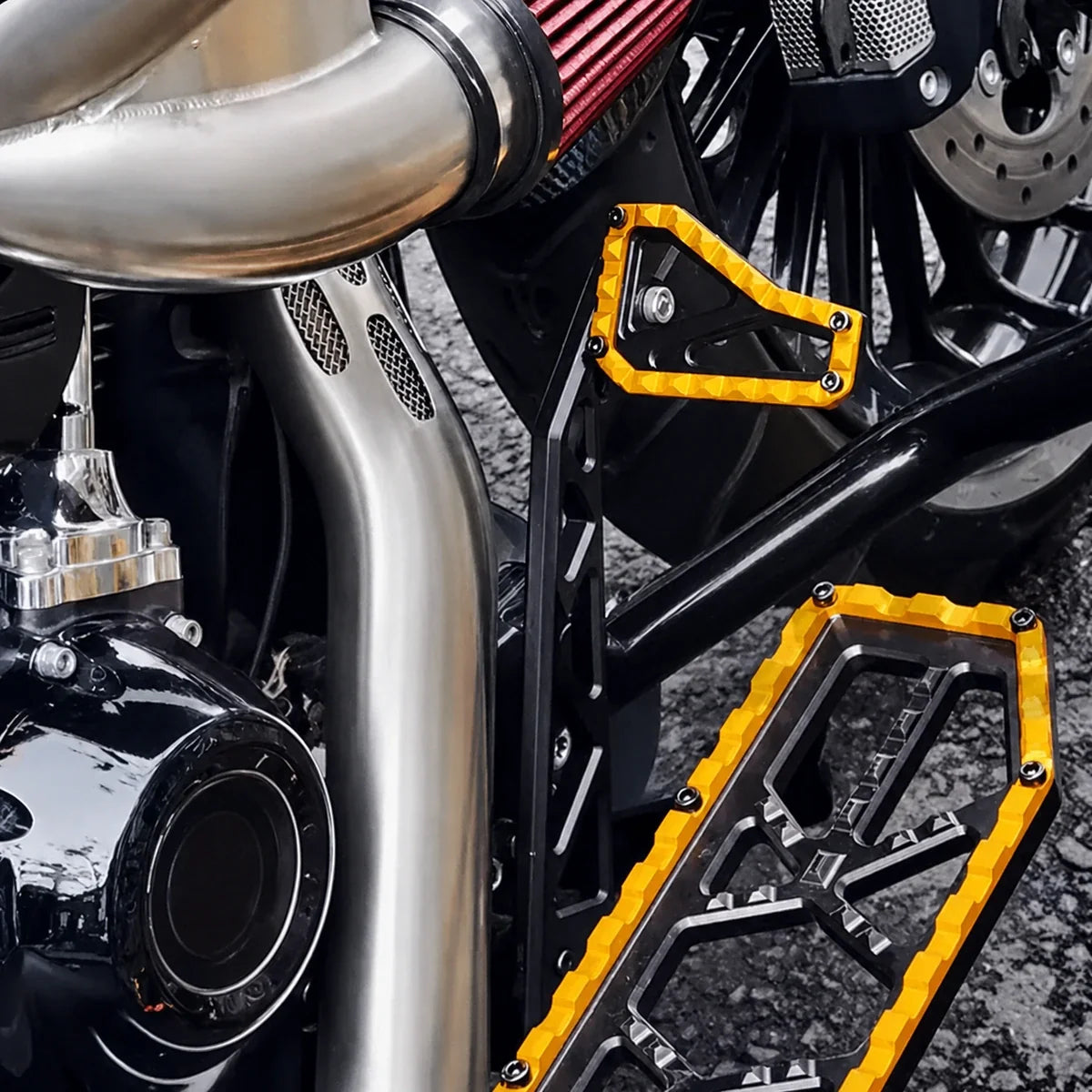 Gold and black PB-style brake pedal and foot controls installed on a compatible Harley motorcycle