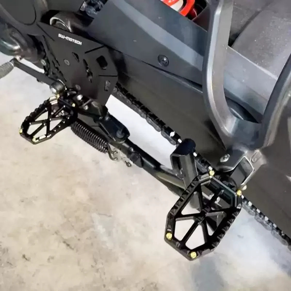 PB-style front and rear motorcycle foot pegs shown at rider control positions