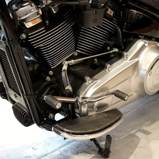 Chrome heel-toe shift lever set installed on a Harley Softail