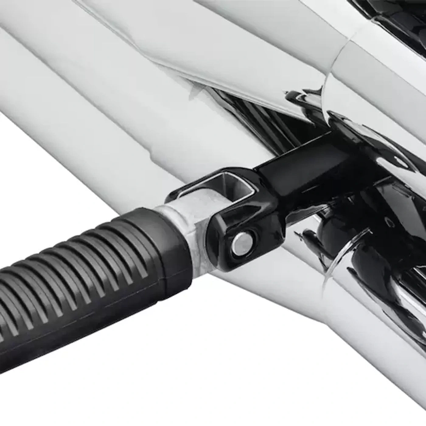 Close-up of passenger foot peg support bracket installed on a Harley Softail