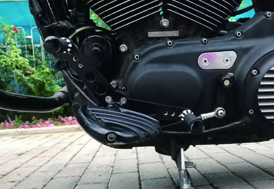 Black forward-control shifter installed on a Harley Sportster