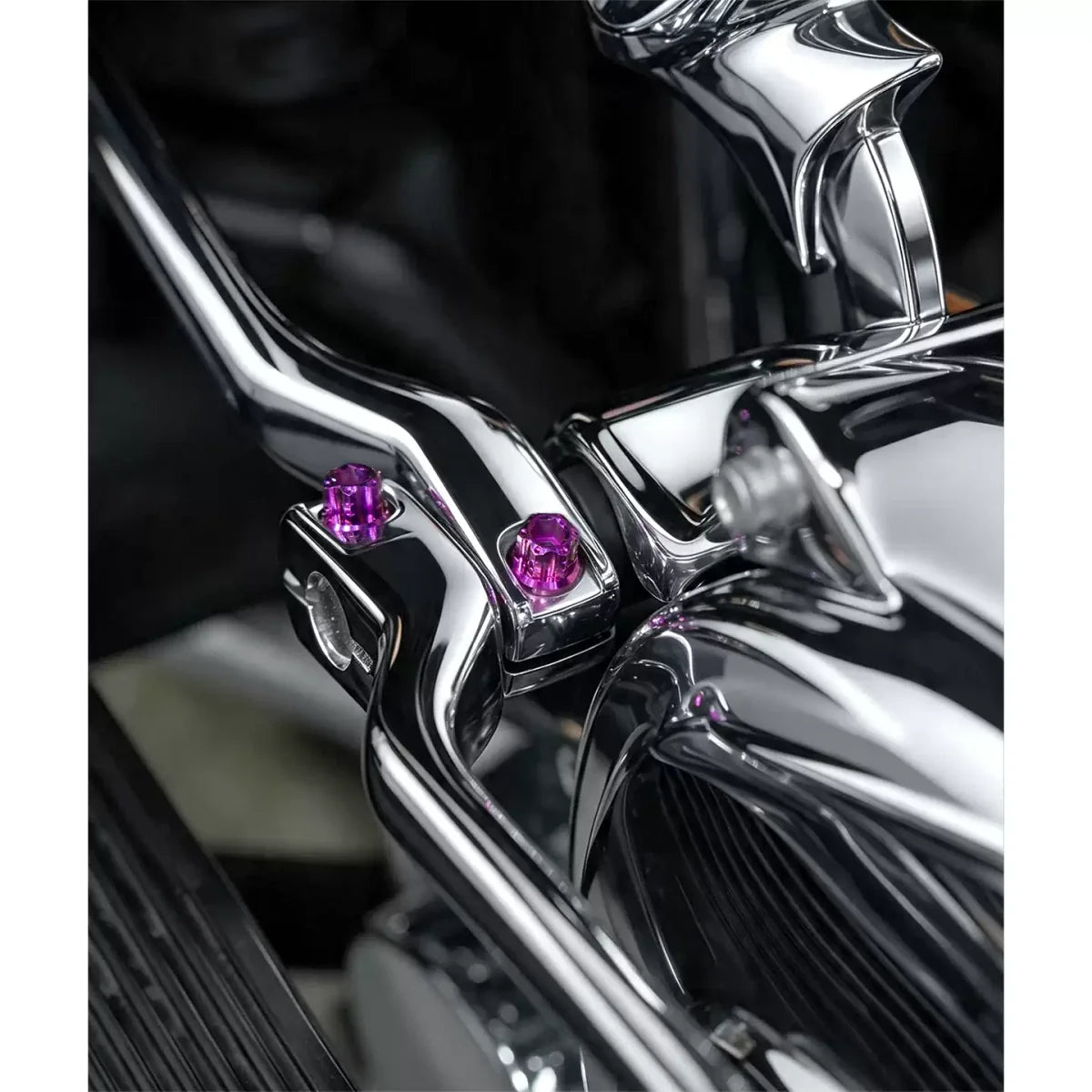 Purple titanium foot-control bolts installed on a Harley motorcycle