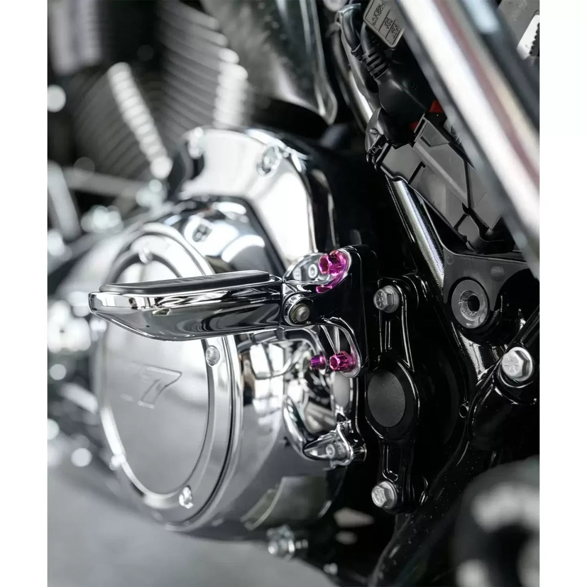Purple titanium shift lever bolts installed on a Harley motorcycle